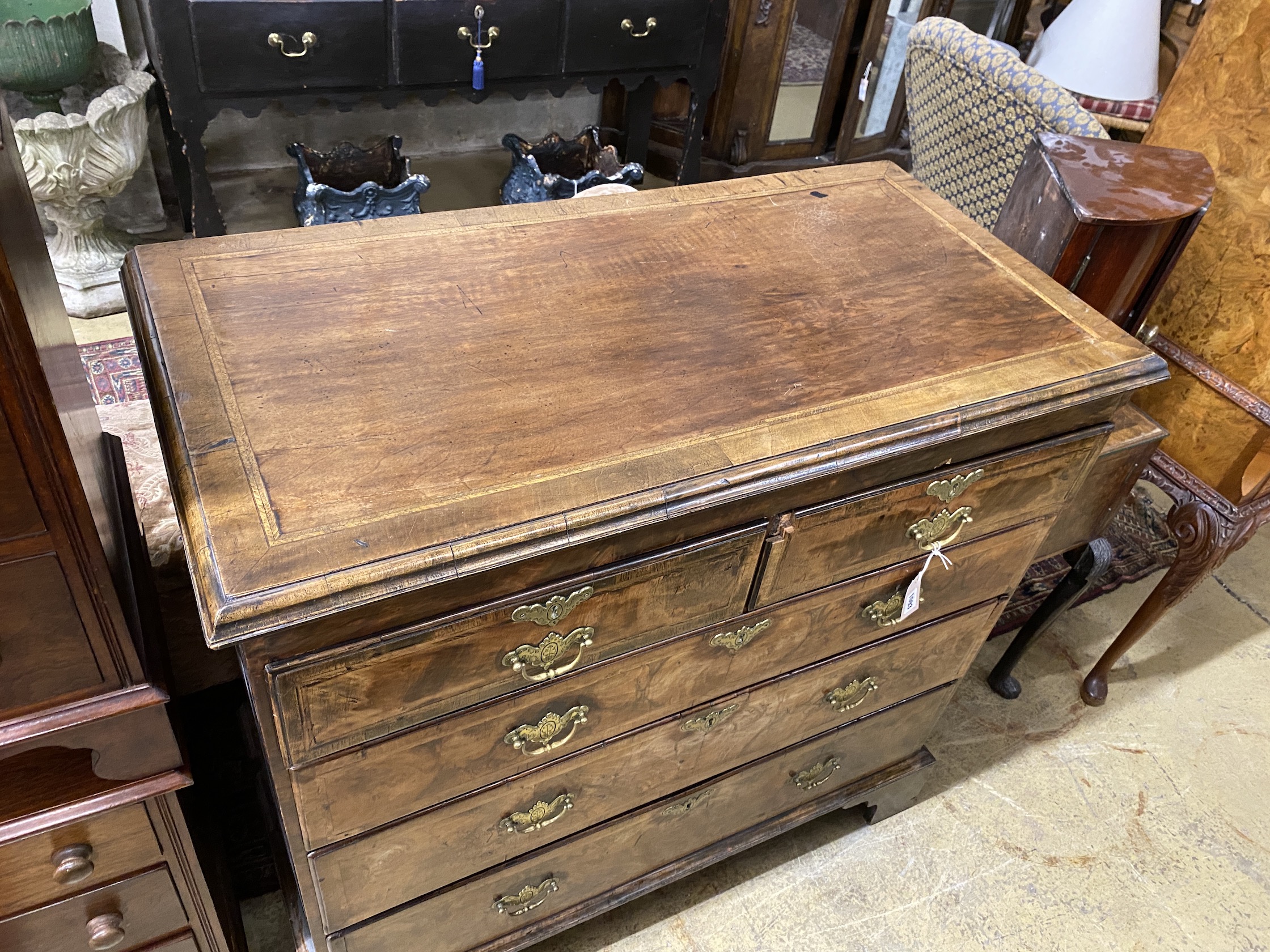 An 18th century feather banded walnut chest of drawers, width 104cm, depth 53cm, height 100cm